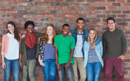 Portrait of a group of university students standing in their university building.